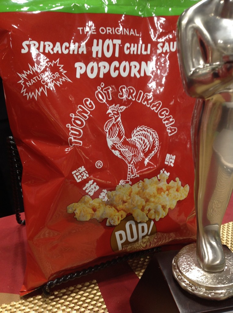 Google "sriracha popcorn" and a bunch of companies come up. But Pop! Gourmet Popcorn cleverly turned their package into a Sriracha-lover's magnet — red hot. Check out their shirts. Their use of the Sriracha brand is a winner for Sriracha appeal. 